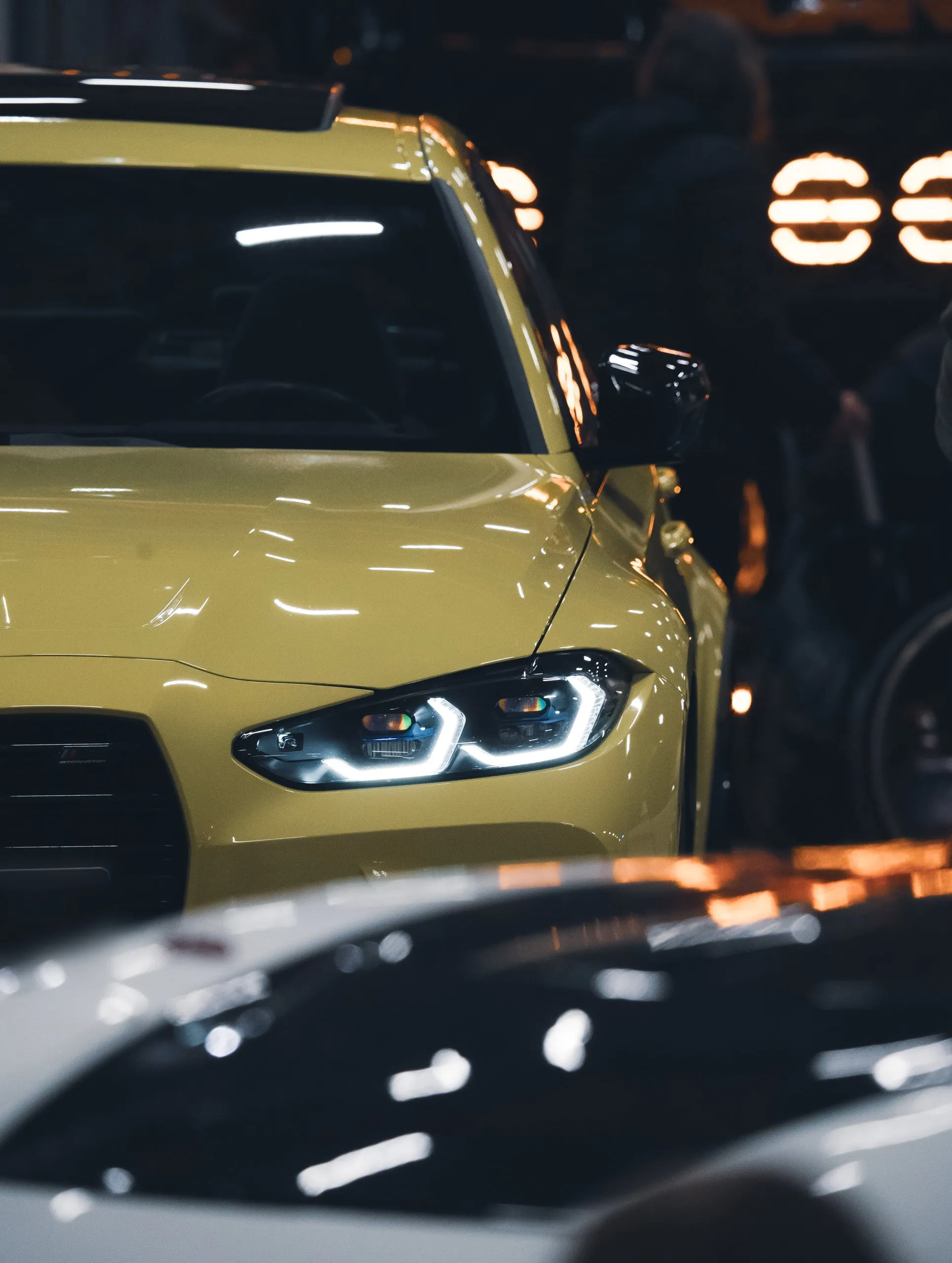 Yellow BMW M4 under the hall lights