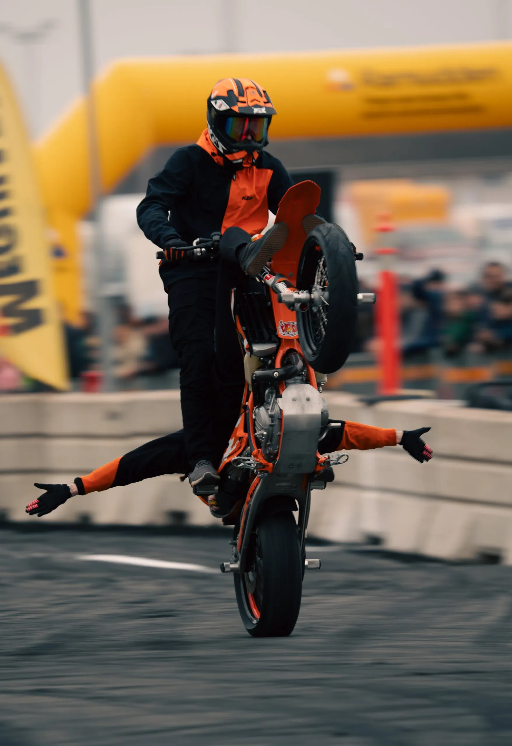 Stunt rider doing a no-feet trick on the rear wheel