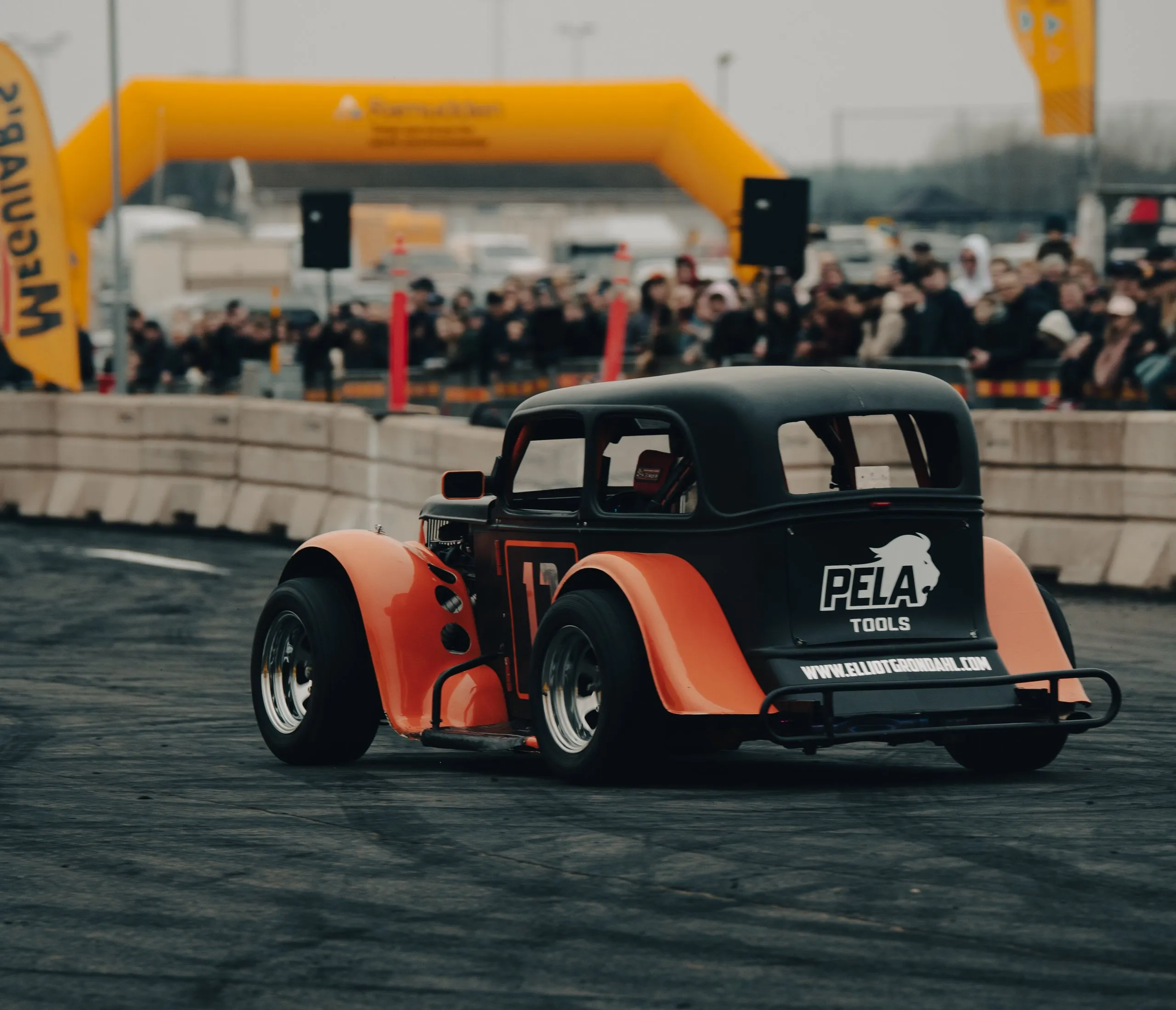 Orange and black hot rod in the arena