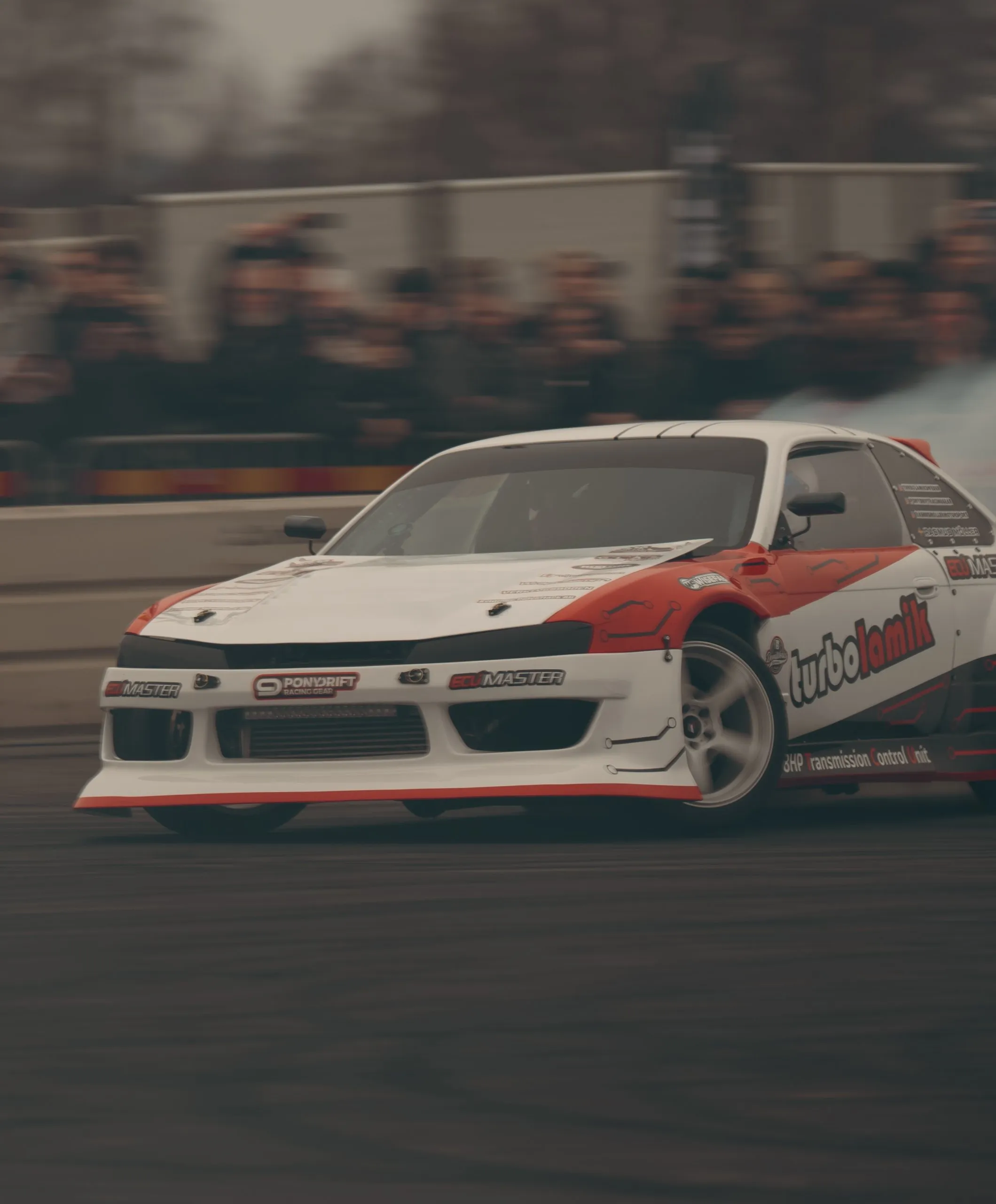 White and red drift car in full slide